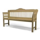 A Scandinavian cream painted garden bench, 20th Century, the shaped crest rail above spindle back,