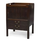 A mahogany tambour fronted commode, 19th century, the rectangular top with raised gallery and