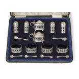 A George V silver and blue glass condiment set, London, c.1918, Reid & Sons., in original fitted