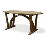 Peter Southall, a lime oak dining table, of recent manufacture, the oval top on curved laminated