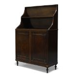A Regency and later mahogany waterfall bookcase cabinet, with two open shelves, above two cupboard