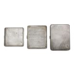 Three 1920s silver cigarette cases, each with push button thumb piece and gilded interior, one of