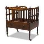 An early Victorian rosewood canterbury, with four divisions, pierced handle and turned supports,