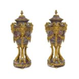 A pair of Louis XVI style gilt-bronze mounted breccia violette marble urns, 19th century, each