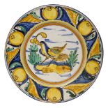 A Continental Maiolica charger, 19th century, of circular form, decorated in central polychrome bird