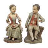 A pair of German polychrome decorated wood figures of apple sellers, early 19th century, each