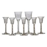 A group of five drinking glasses, 19th century, each with bell shaped bowls, finely engraved with