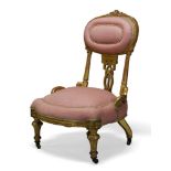 A Victorian gilt wood nursing chair, the oval backrest centred by carved ribbon, above pierced