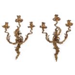 A pair of French Louis XV style gilt-bronze three-light wall appliques, late 19th century, of