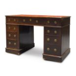 An oak pedestal desk, 19th century, the rounded rectangular top inset with red leather writing