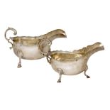 Two silver sauce boats, the larger example Birmingham, c.1911, Williams Ltd., raised on three