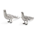 A pair of Continental white metal pheasants with articulated wings, the body of each realistically
