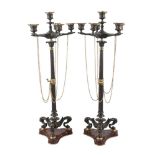 A pair of French gilt and patinated bronze six-light candelabra, in the manner of Barbedienne, c.
