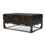 A Chinese black lacquer and gilt trunk on stand, first half 20th Century, overall decorated with