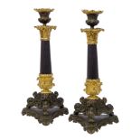 A pair of French gilt and patinated bronze candlesticks, late 19th century, with Corinthian