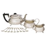 A three-piece silver tea set, Birmingham, c.1922, F. H. Adams & Cote, comprising a teapot, sugar