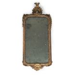 An Italian giltwood mirror, probably Venetian, 19th century, with cresting and apron centred by a
