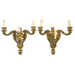 A pair of French gilt-bronze three-light wall appliques, early 20th century, the backplates inset