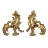 A pair of French Louis XV style ormolu chenets, 19th century, the scrolling acanthus standards