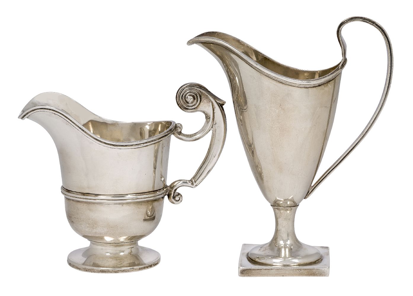 Two silver cream jugs, one Chester, c.1896, Florence Warden, of helmet design and raised on a square