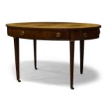 A George III mahogany oval writing table, the oval top inset with green leather writing surface,