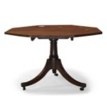 A Regency mahogany tilt top breakfast table, the octagonal top on tapering and turned column to