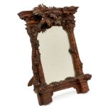 An Italian carved walnut table mirror, mid 19th century, of architectural form, the fluted columns