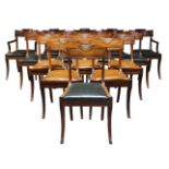 A set of sixteen Regency mahogany dining chairs, the top rails with carved drapery, on curved