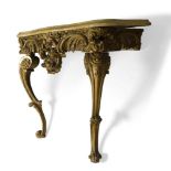 A Victorian giltwood console table, with serpentine yellow marble top, above elaborately carved
