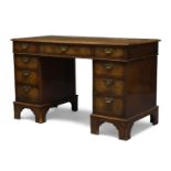 A George III style mahogany pedestal desk, early 20th century, the rectangular top inset with