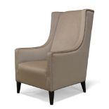 A modern wingback armchair, of recent manufacture, upholstered in fawn velvet material, on square