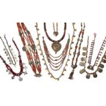 A collection of African occasion necklaces, to include: a coral bead and shell necklace, designed