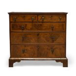 A George I and later walnut and featherbanded chest of drawers, with a quarter veneered top, above