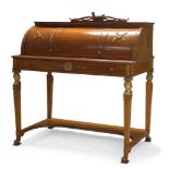 An Empire style mahogany and parcel gilt cylinder bureau, the top surmount with carved bow and