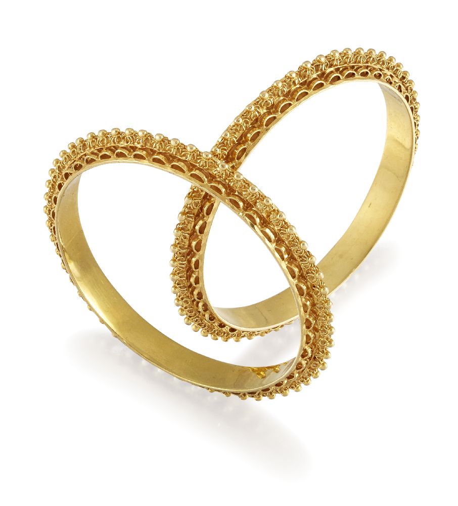 Two bangles, of matching hoop design with raised bead and openwork decoration, internal diam. 5.
