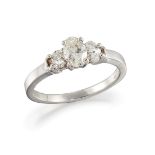 A diamond three stone ring, composed of three graduated oval brilliant-cut diamonds, ring size