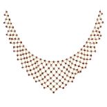 A ruby necklace, of tapered lattice design composed of a series of circular ruby collets with