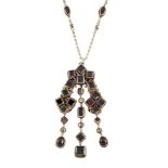 A late 19th century Austro-Hungarian silver-gilt and garnet pendant necklace, the arched pendant set