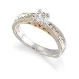 A diamond single stone ring, the brilliant-cut diamond in claw mount to channel-set graduated