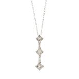 A diamond pendant, the three princess-cut diamonds with baguette-cut diamond single stone spacers,