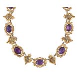 An early Victorian gilt-mounted purple paste necklace, composed of a a series of oval purple