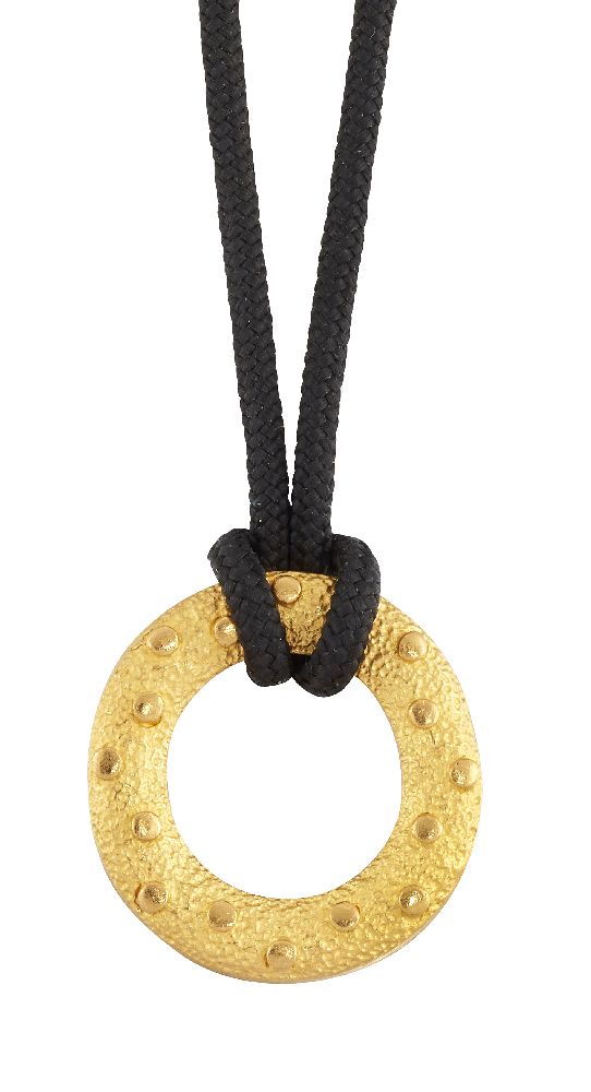 A pendant necklace, the circular textured loop pendant with raised circular disc detail, to a fabric