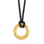 A pendant necklace, the circular textured loop pendant with raised circular disc detail, to a fabric