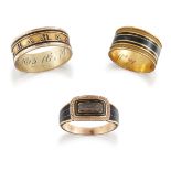 Three George III gold and enamel mourning rings, comprising: a broad band with triple black enamel