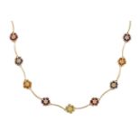 A multi-gem necklace, composed of a series of circular-cut gem flowerheads with curved bars between,