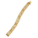 A late 19th century French gold, diamond and ruby articulated panel bracelet, designed as a series