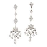 A pair of diamond pendant earrings, each flowerhead cluster with tassel drops to quatrefoil