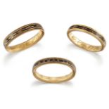 Three George III gold and black enamel mourning rings, comprising: one with black enamel band