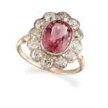 A pink tourmaline and diamond cluster ring, the collet-set oval mixed-cut pink tourmaline with