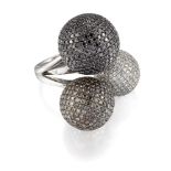 A diamond and coloured diamond dress ring, composed of three graduated spheres, pavé set with